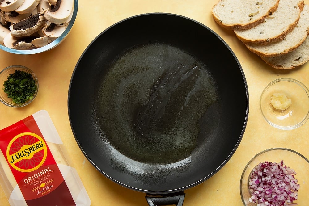 A frying pan with butter melted in it.