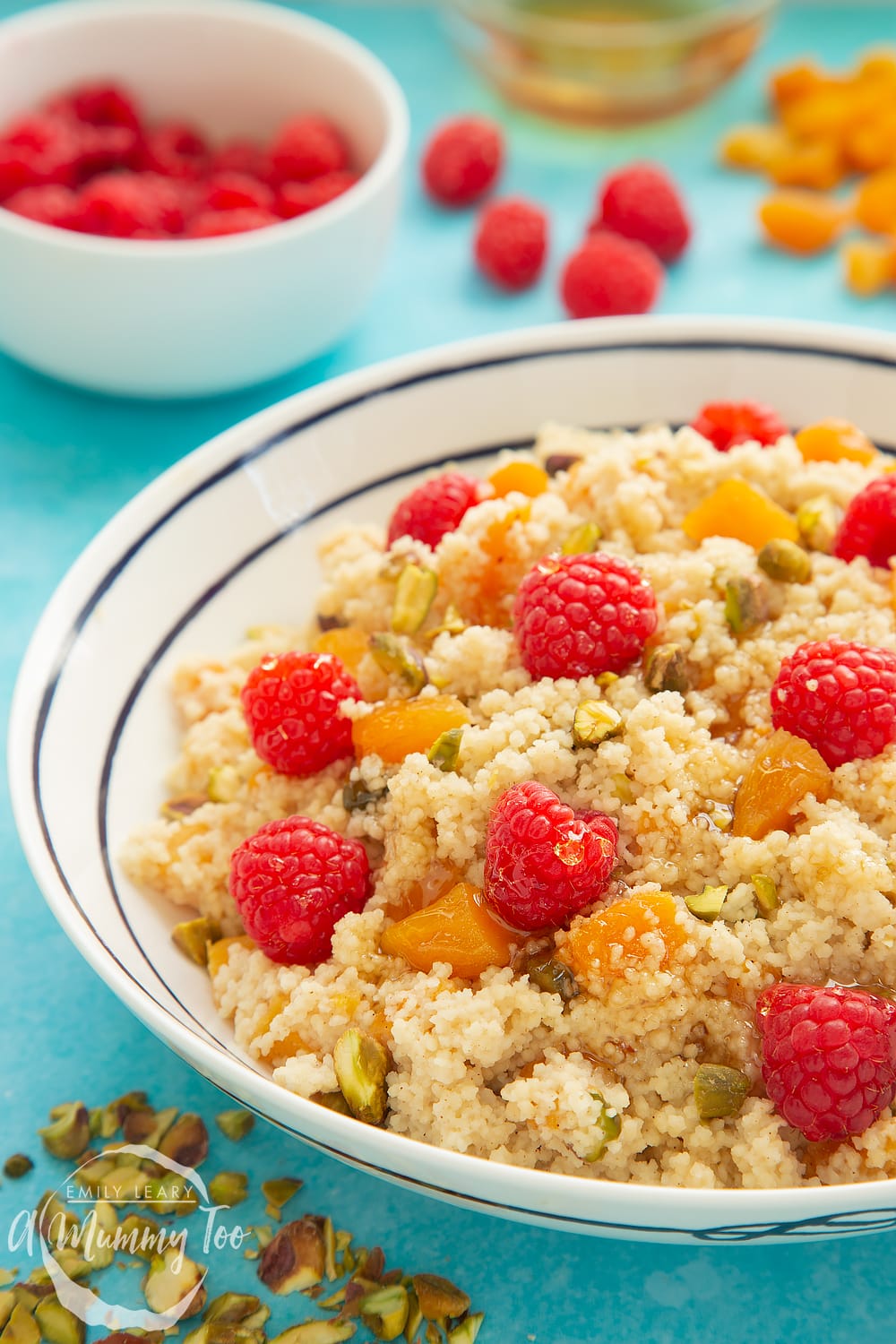 Close up shot of the sweet breakfast couscous. In the background you can see the dried apricots and the raspberries. 