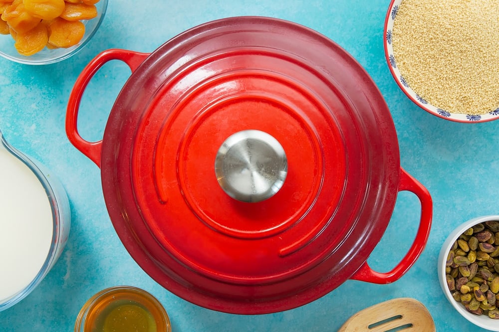 Overhead shot of the pan lid covering the ingredients which have been mixed together inside the pan. 