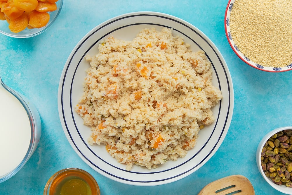 Over head shot of a white bowl with black decoration with sweet breakfast couscous. 