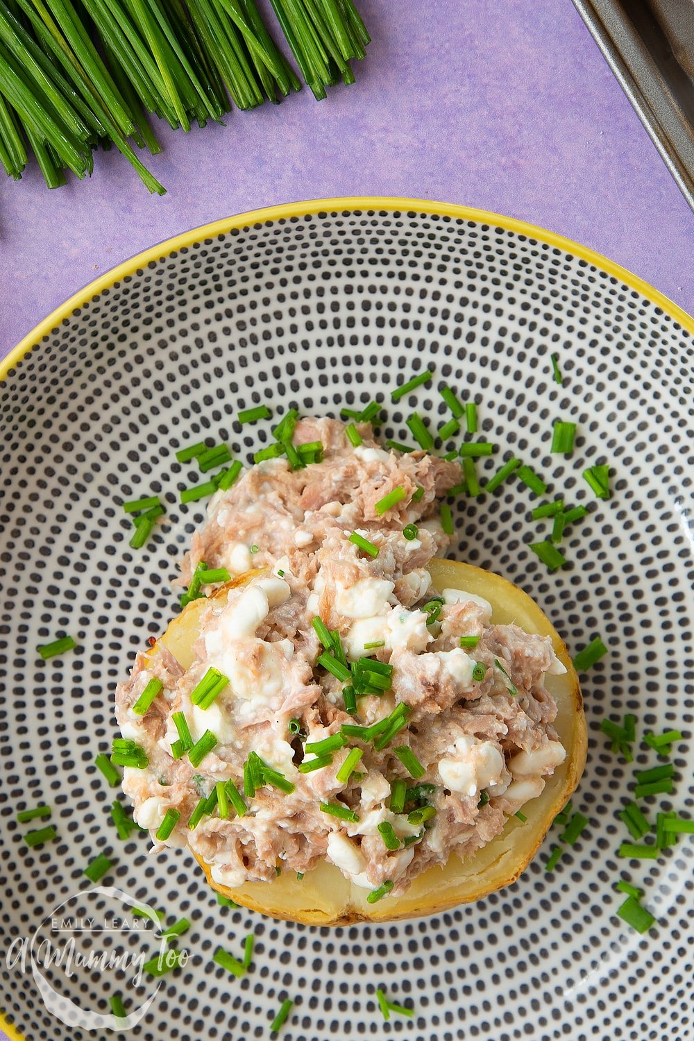 A finished serving of low-fat tuna cheese jacket potato on a plate.