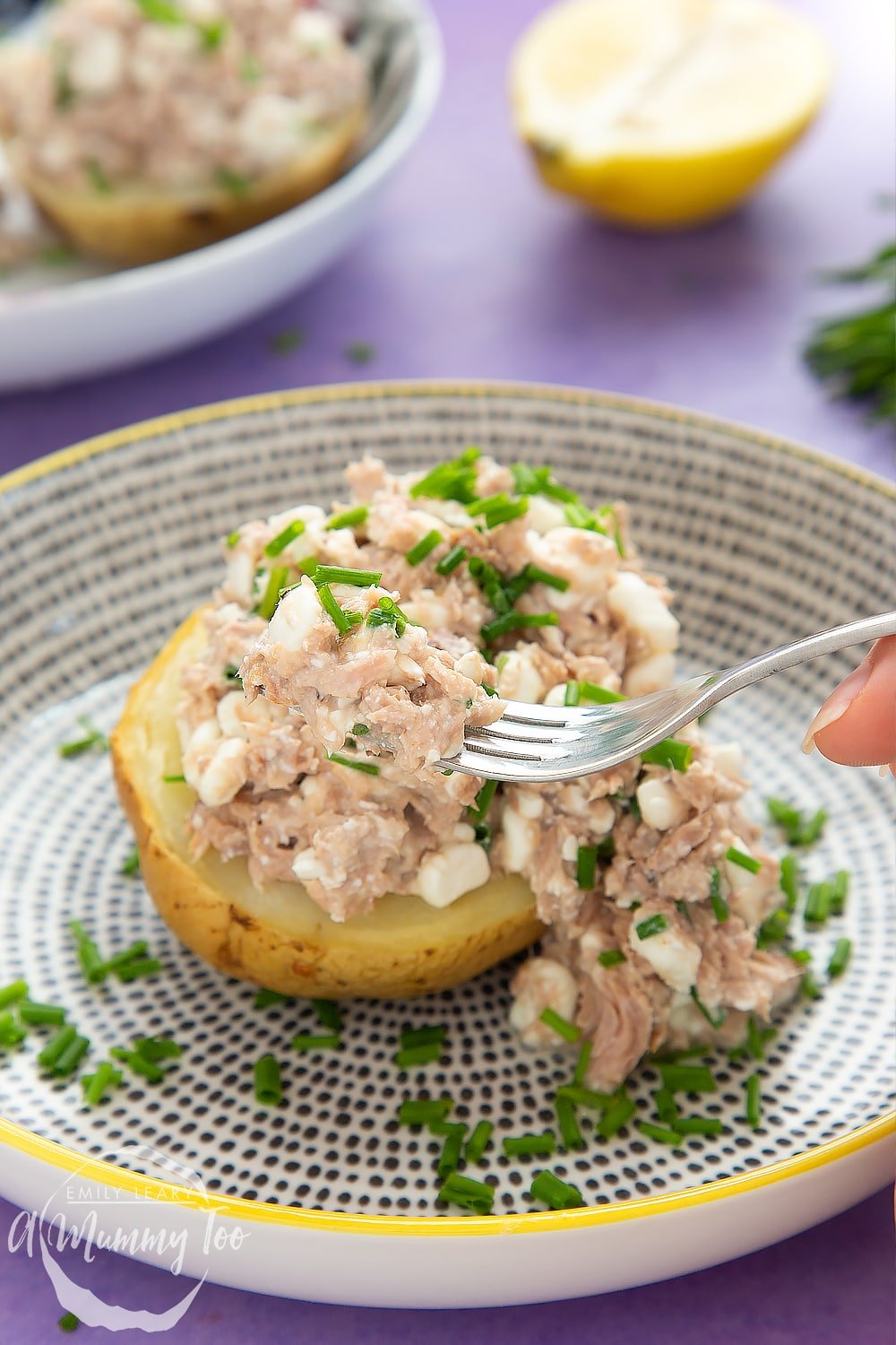 A fork full of the low-fat tuna cheese jacket potato ready to be eaten. 