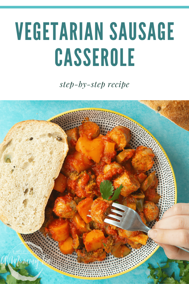 Overhead shot of the Slow-cooked vegetarian sausage casserole in a decorative bowl ontop of a blue table. At the side of the bowl there's a slice of bread and at the top of the image there's some blue text on a white background describing the image for Pinterest.