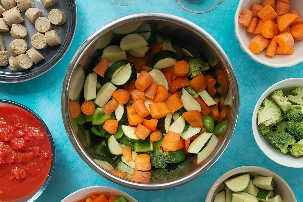 Overhead shot of the bowl of ingredients for the Slow-cooked vegetarian sausage casserole. 