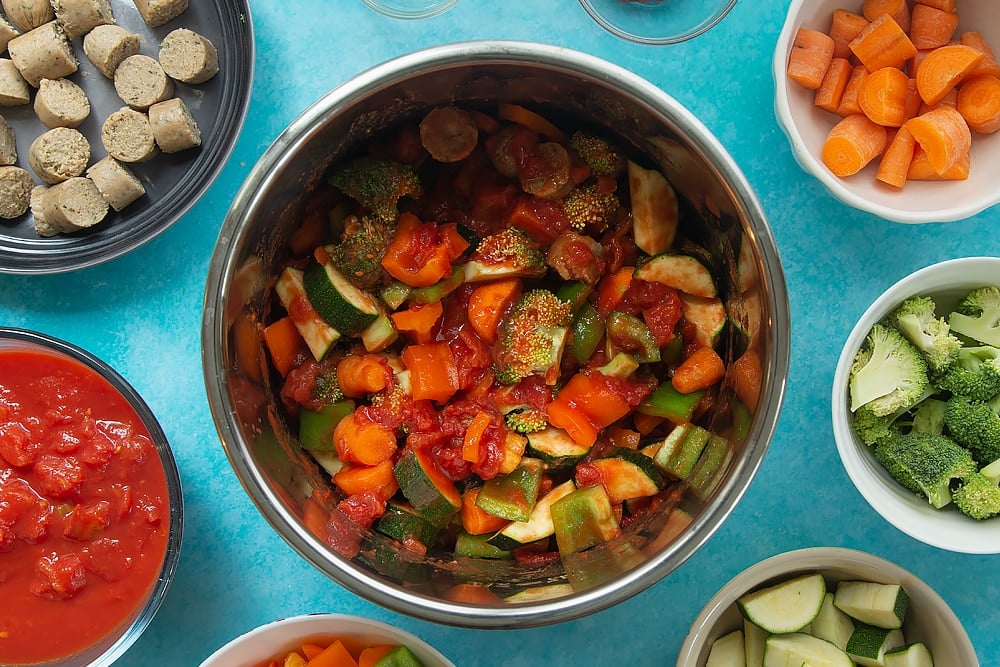 Overhead shot of the Slow-cooked vegetarian sausage casserole ingredients being mixed togther. 