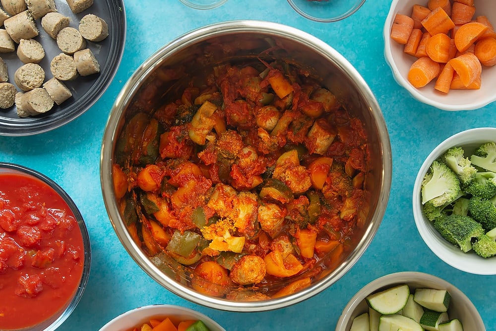 The Slow-cooked vegetarian sausage casserole ingredients having been cooked in the slow cooker for one hour.