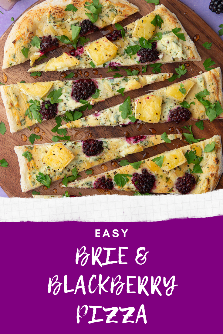 Brie and blackberry pizza sliced on a wooden board and scattered with fresh parsley. Caption reads: Easy brie & blackberry pizza.