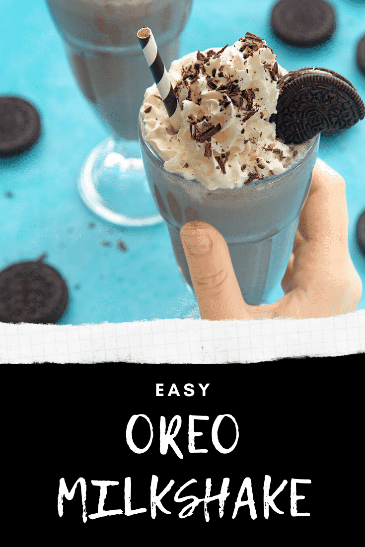 Hand holding an oreo milkshake with an additional milkshake in the background on a light blue table. At the bottom of the image there's some text describing the image for Pinterest. 