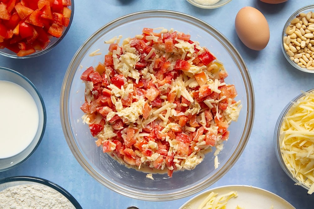 Some of the cheese and red pepper muffins ingredients mixed together in a bowl. 