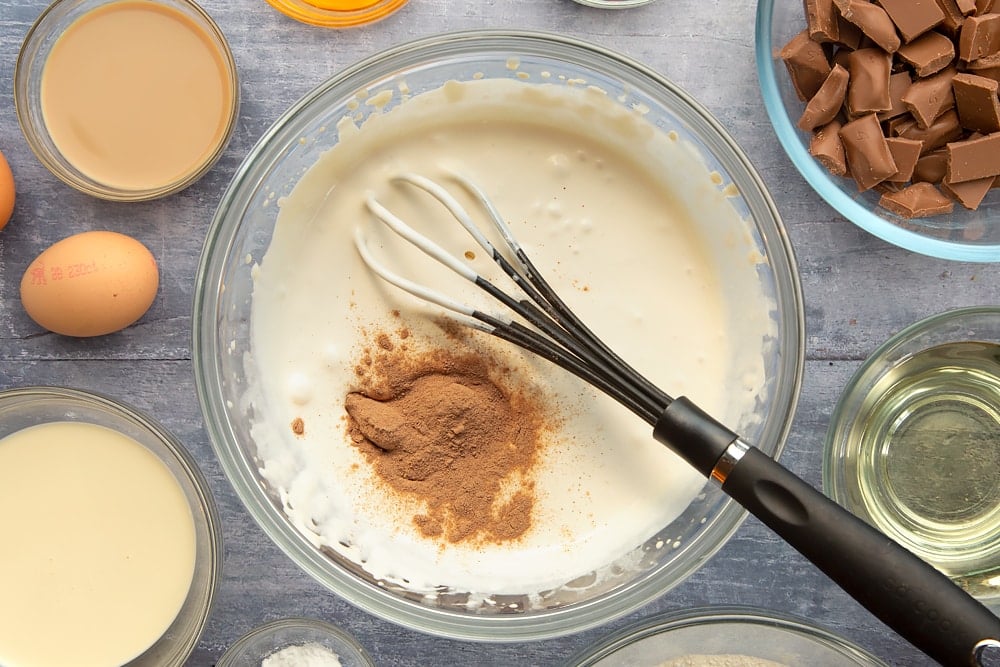 Adding the drinking chocolate to the Bailey's mixing bowl for the galaxy chocolate cake