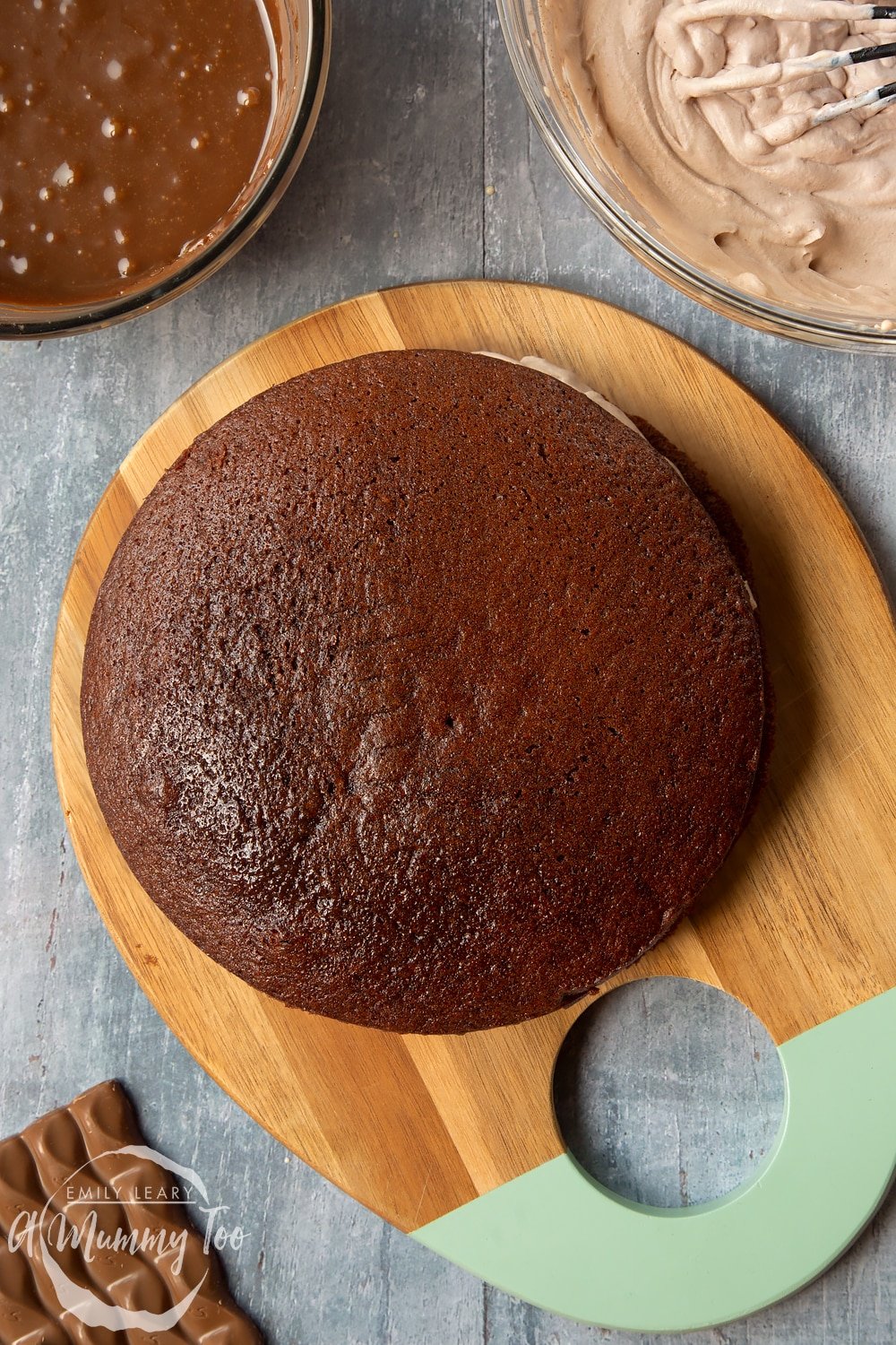 Adding the second galaxy chocolate cake sponge to the cake. 