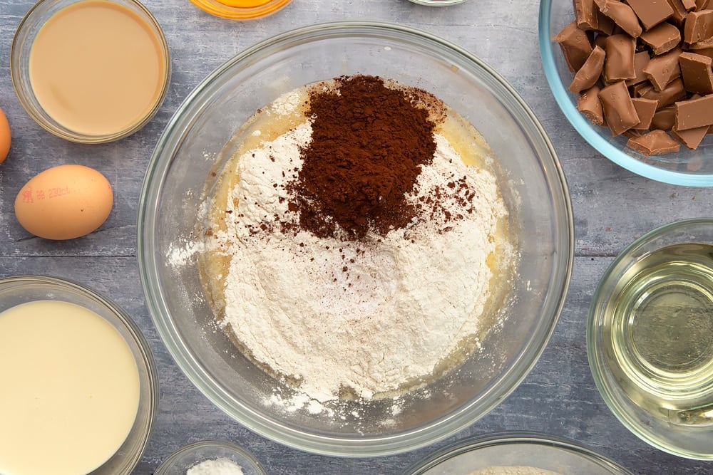 Flour, bicarb and cocoa powder being added to the galaxy chocolate cake mixture. 