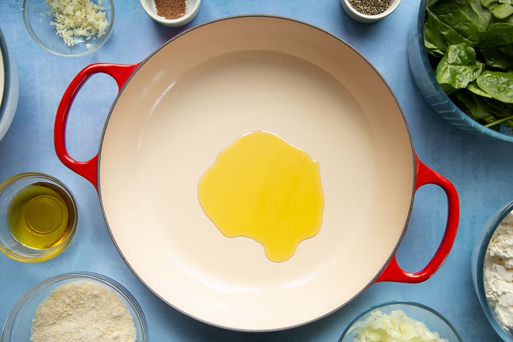 Overhead shot of olive oil in a red pan