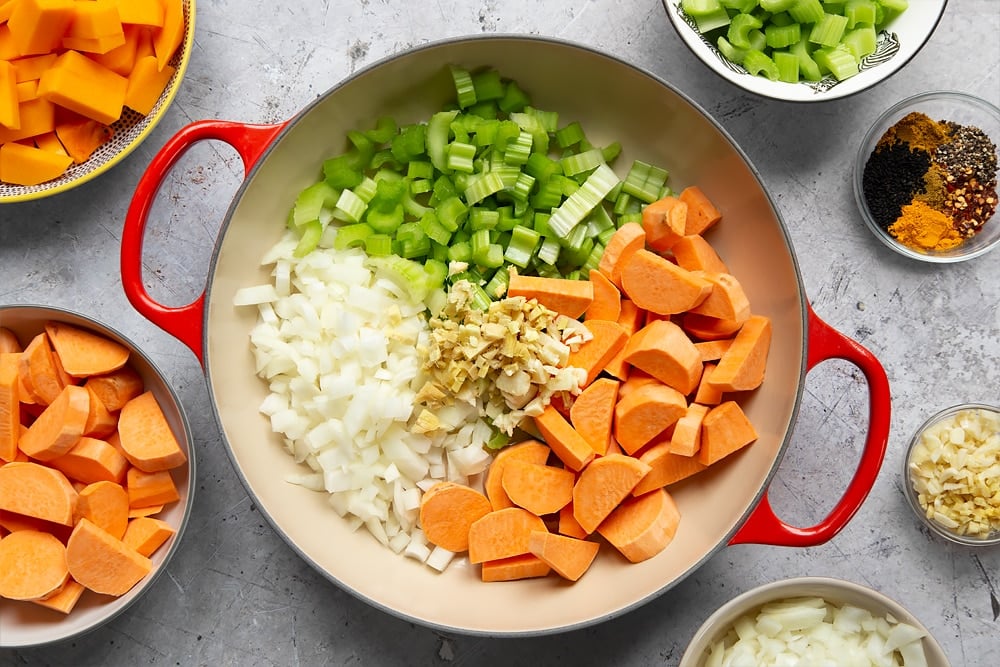 Adding the ingredients for the butternut squash and chickpea curry to the heated pan. 