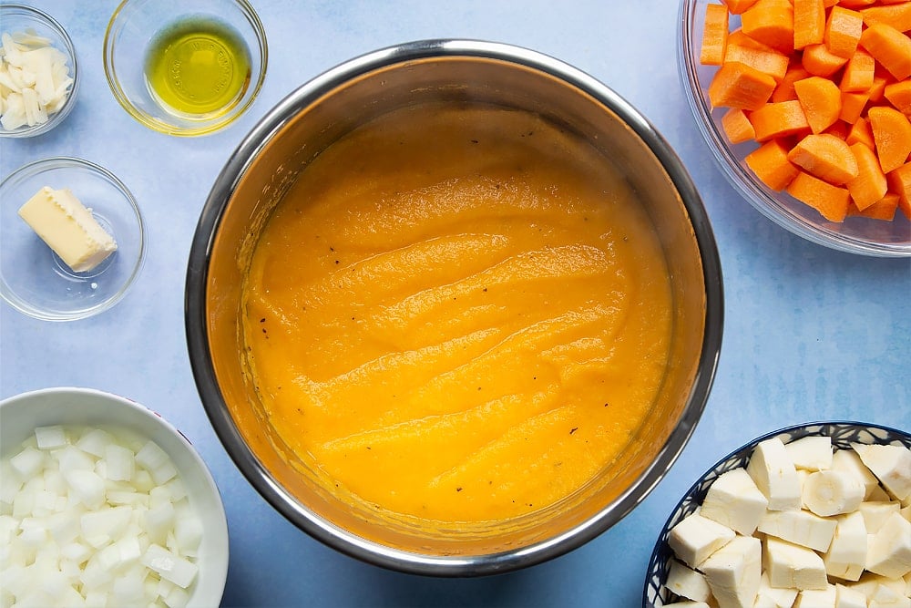 The carrot and parsnip soup ingredients having been blitzed with a blender inside the pan.