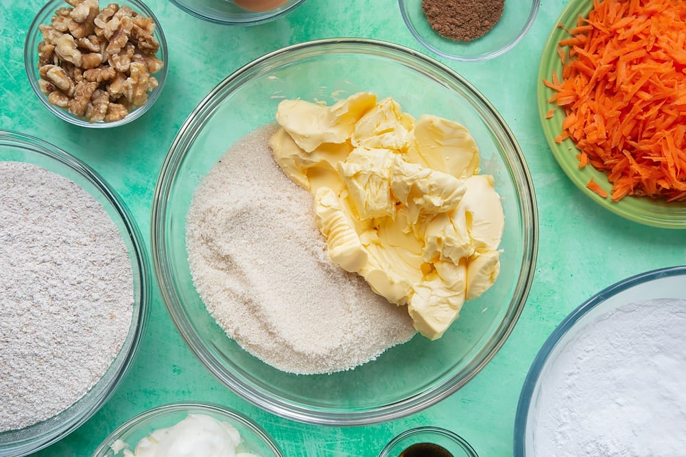 Start creating the carrot cake tray bake mixture by combining the margarine with sugar.