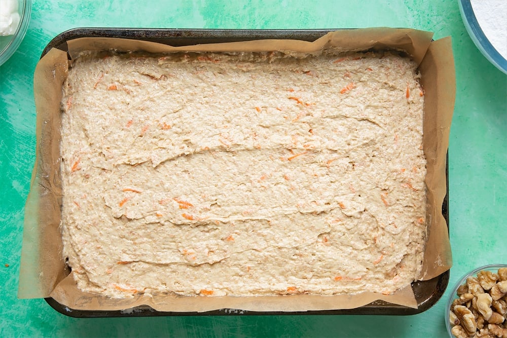 Levelling the carrot cake tray bake batter in the baking tin. 