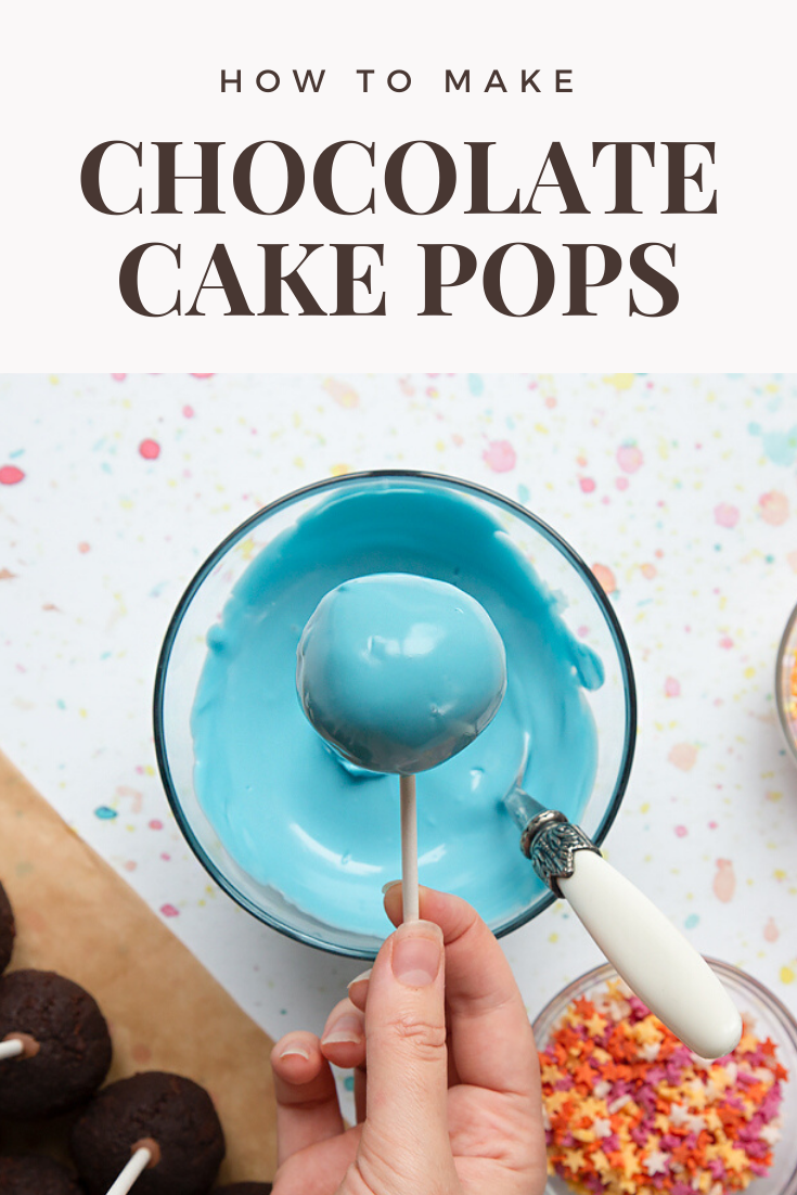 Overhead shot of chocolate cake covered in blue icing chocolate. Inside the bowl of blue there's a decorative spoon. Meanwhile at the top of the image there's some text describing the image for Pinterest.