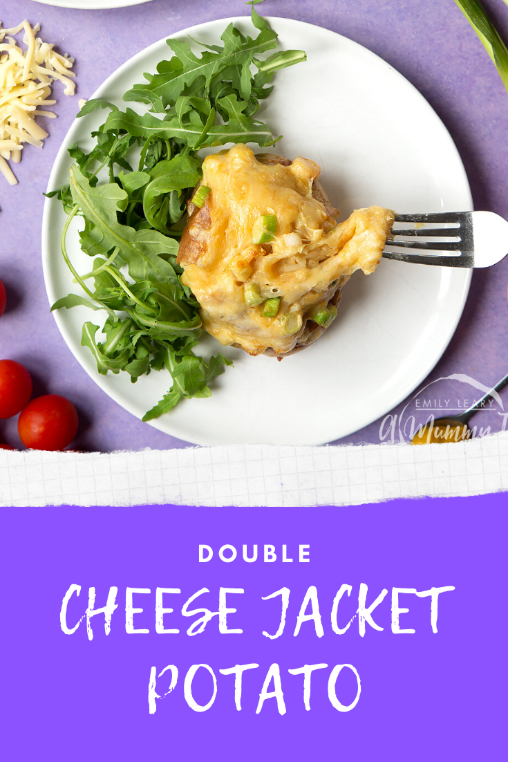 A cheese and onion jacket potato served on a white plate with rocket. Caption reads: double cheese jacket potato