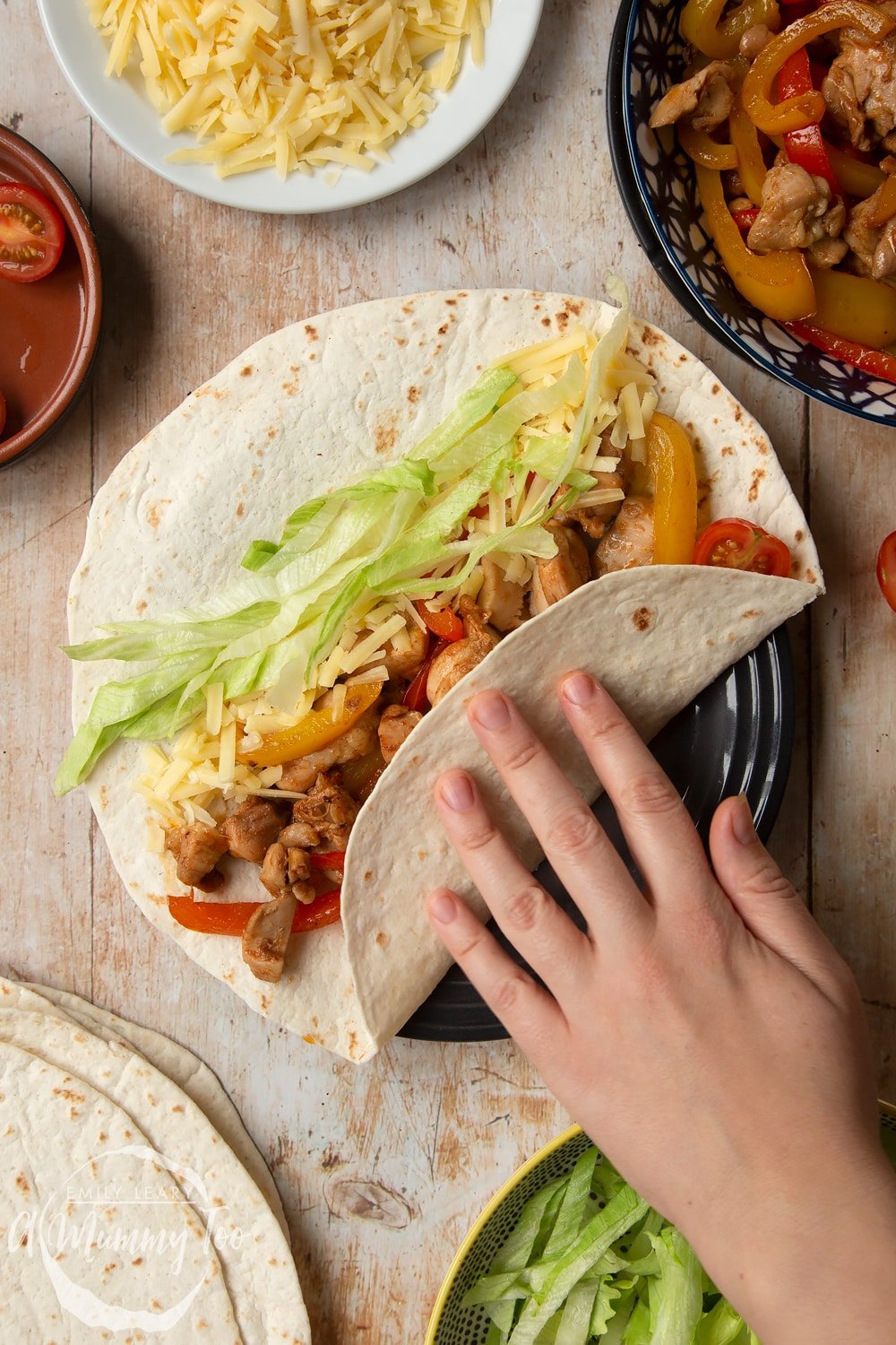 Wrapping up the Mild chicken fajitas for kids in a flour tortilla. 