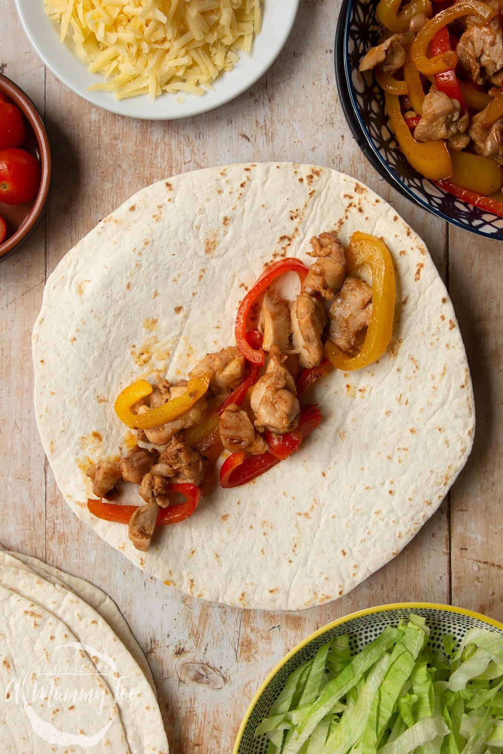 Adding the Mild chicken fajitas for kids chicken to a tortilla.