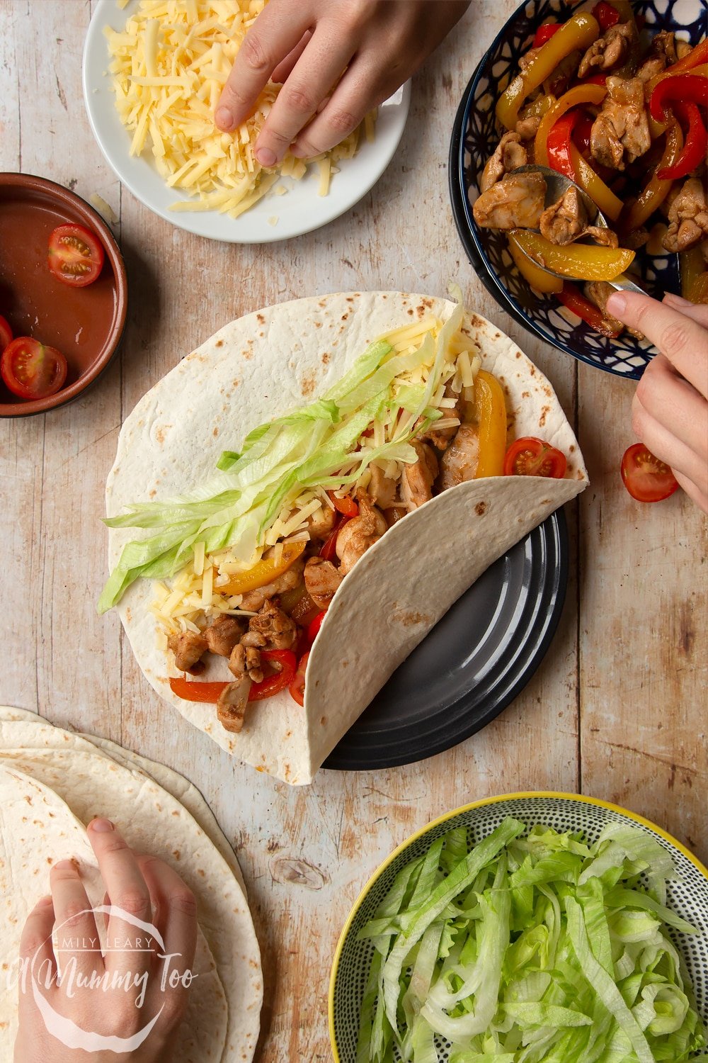 Adding a sprinkle of cheese to the Mild chicken fajitas for kids