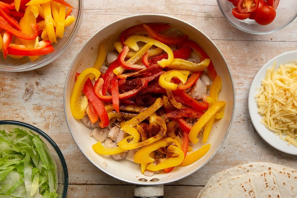 Peppers being added to the pan for the Mild chicken fajitas for kids