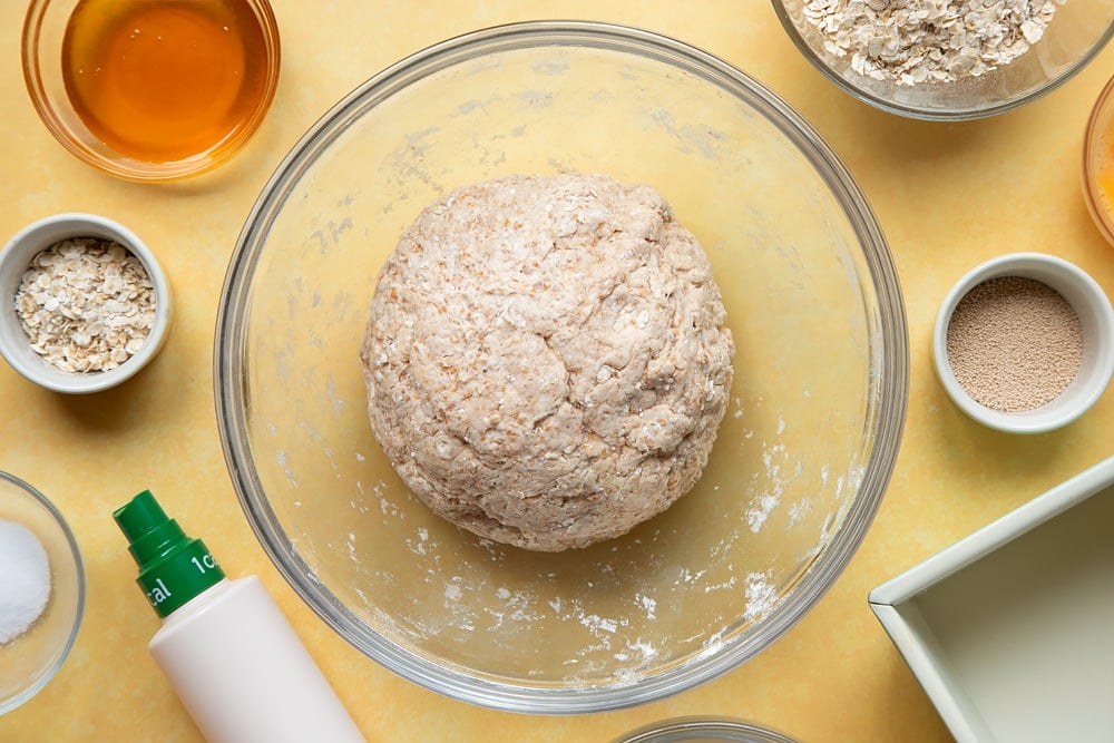 Overhead shot of dough ball in a clear bowl