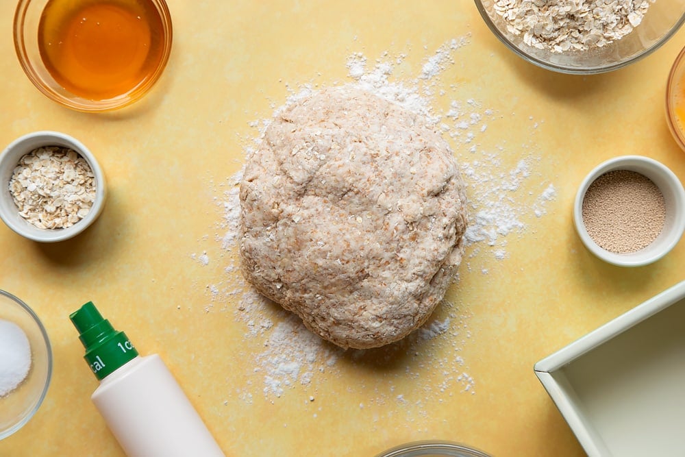 Overhead shot of dough ball with a sprinkle of flour