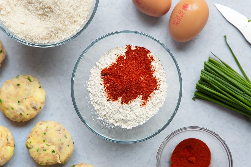 Mixing some paprika and flour together in a bowl.