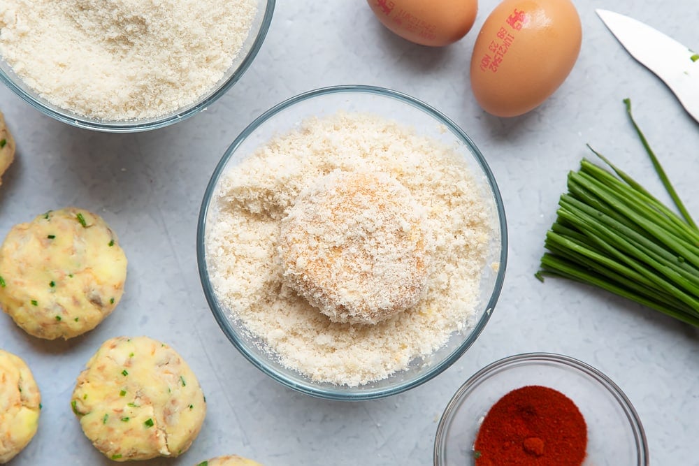 Dipping the fishcake into breadcrumbs bowl ensuring it's covered on all sides.