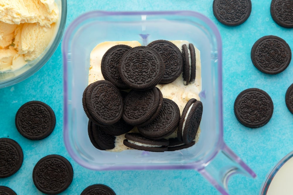 Overhead shot of a blender with the ingredients for an oreo milkshake. 