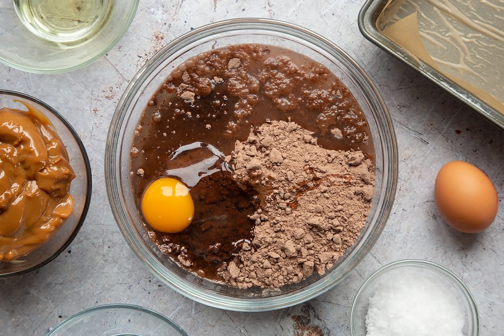 Water, egg and oil added to the  gooey salted caramel brownies mixture. 