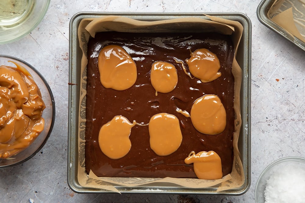 Blobs of caramel on the top of the mixture to create the gooey salted caramel brownies texture