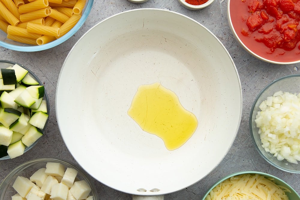 Starting the halloumi pasta bake recipe with olive oil in a pan.