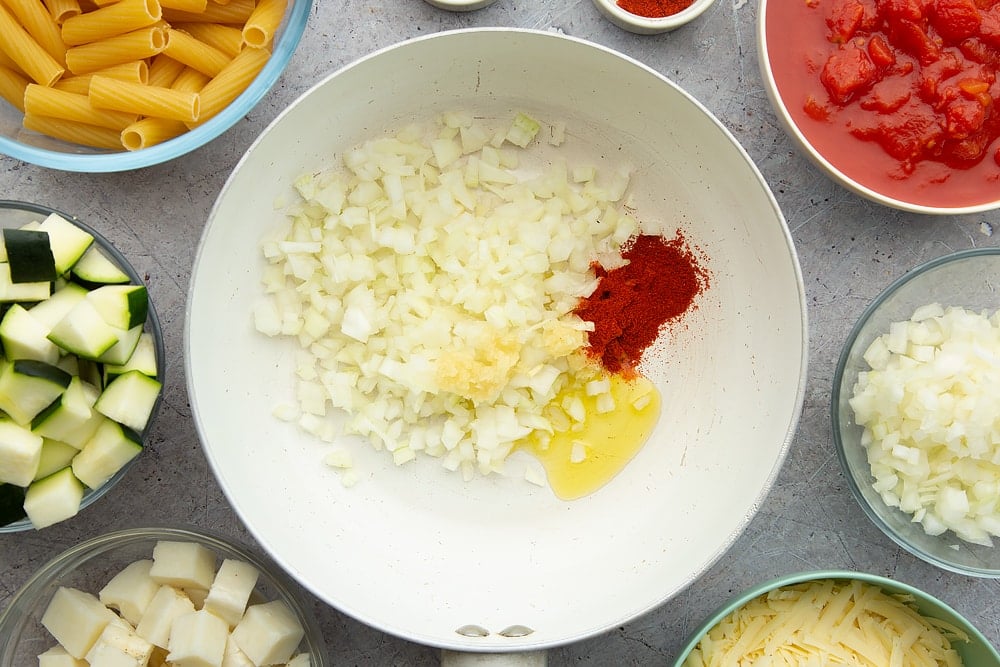 One pan with oil, onions and smoked paprika just a handful of the ingredients you need to get started in making the halloumi pasta bake