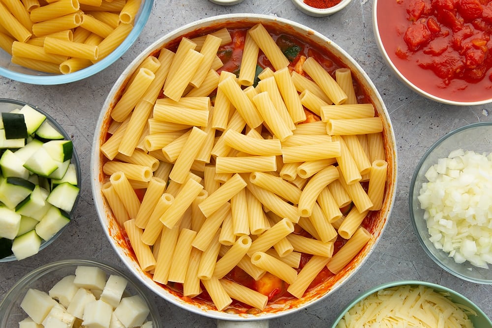 The halloumi pasta bake pan with the pasta added to the top.