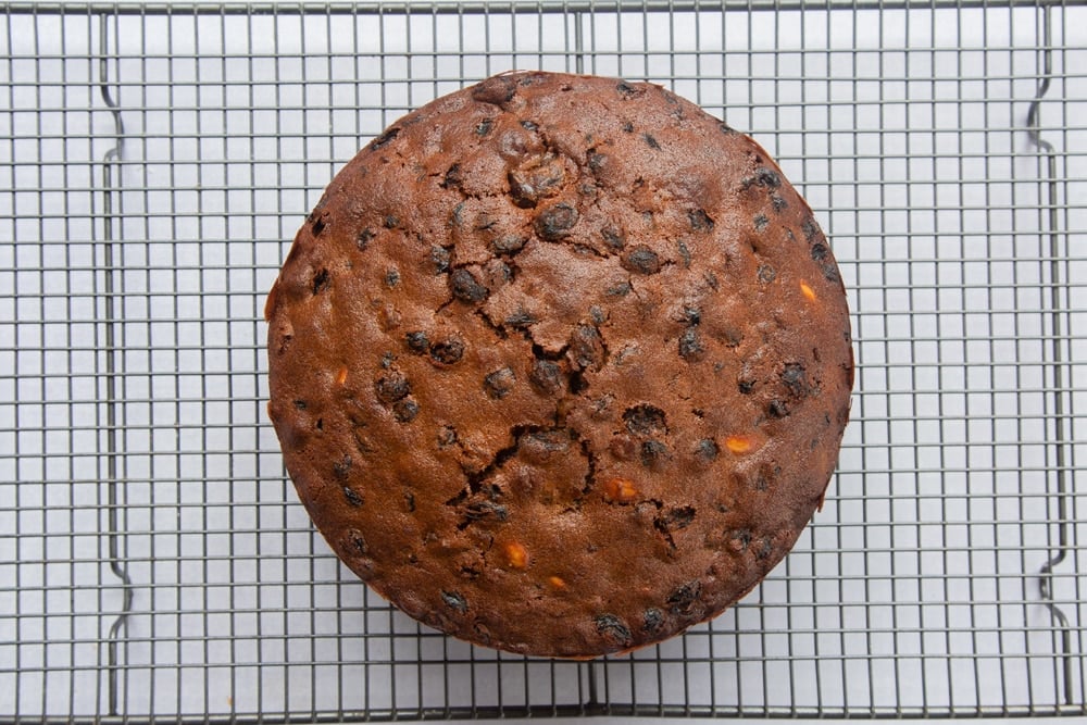 baked christmas fruit cake on a wire cooling rack.