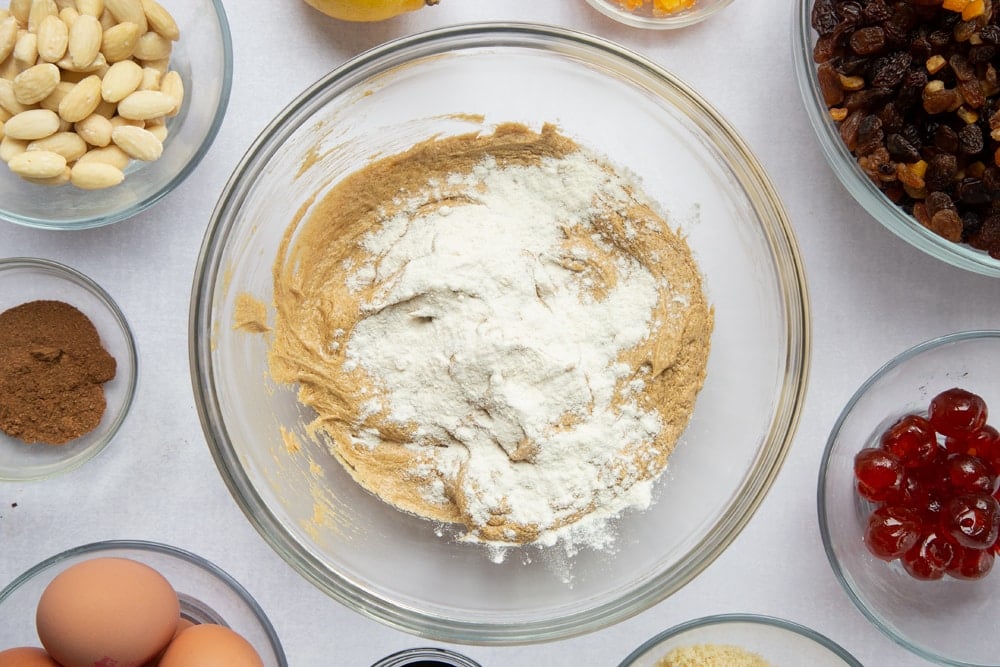 brown sugar, butter and treacle mix creamed together in a large clear bowl topped with flour.