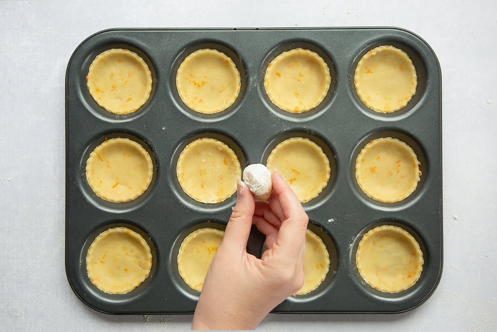 Tin lined with pastry discs. 