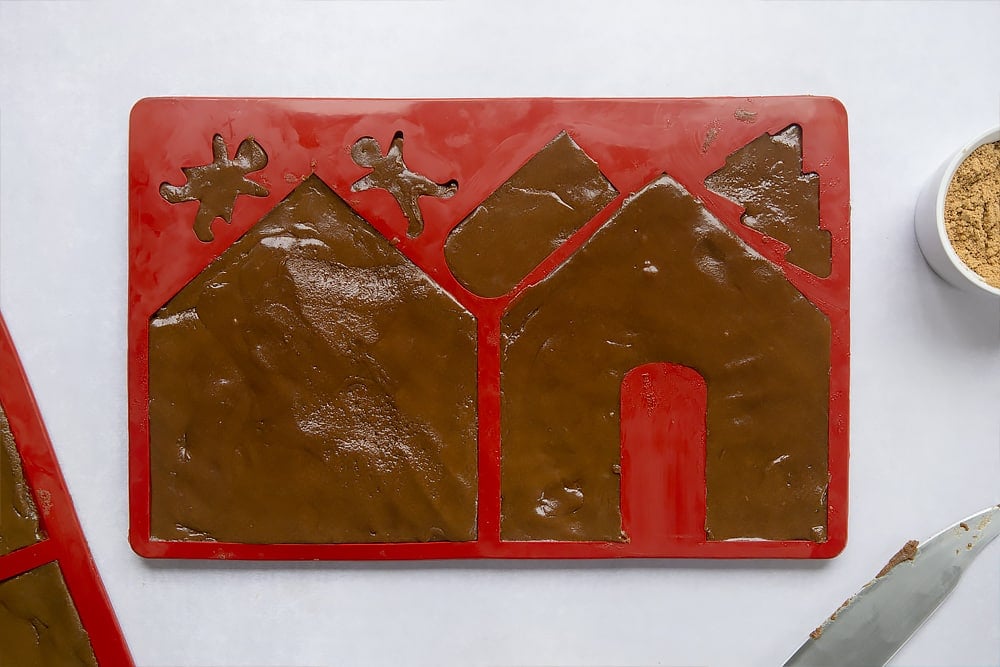 Freshly made gingerbread dough, pressed into a silicone mould designed to shape the pieces needed to construct a gingerbread house.