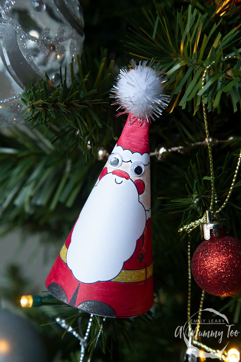 3D Santa which has been decorated and sat on the Christmas tree. 