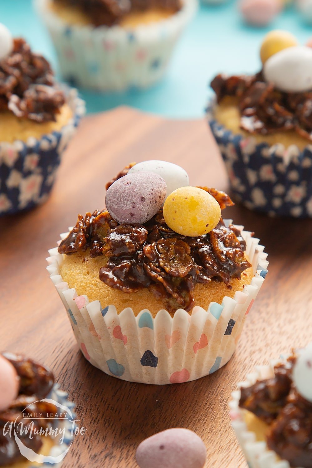 Front angle shot of Easter nest cupcakes served on a wooden plate