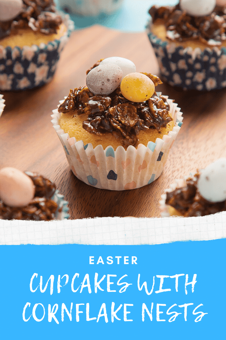 graphic text EASTER CUPCAKES CUPCAKES WITH CORNFLAKE NESTS below Front angle shot of cornflakes easter nest cupcakes served on a wooden plate