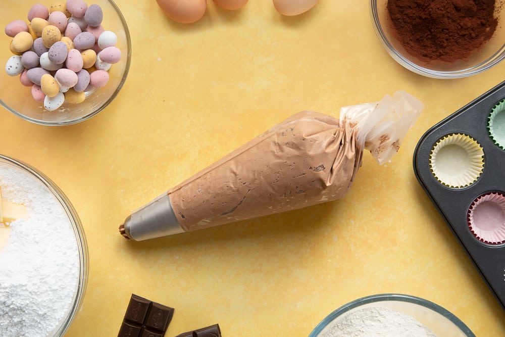 Overhead shot of chocolate frosting in a piping bag