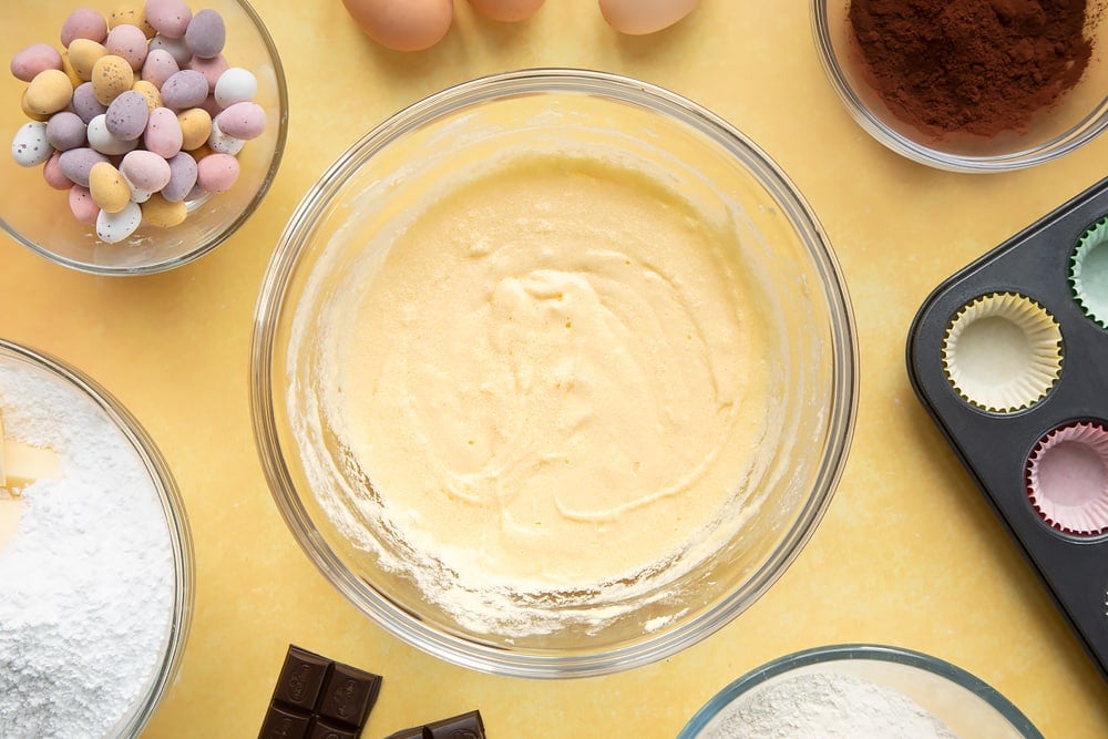 Overhead shot of sponge mix in a large clear bowl