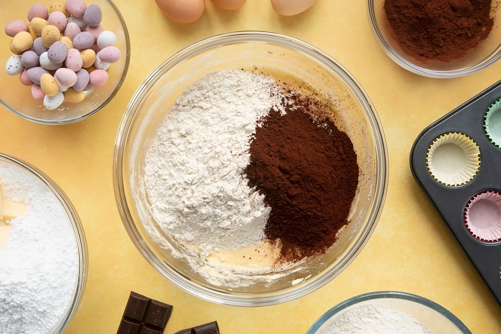 Overhead shot of flour and cocoa in a large clear bowl