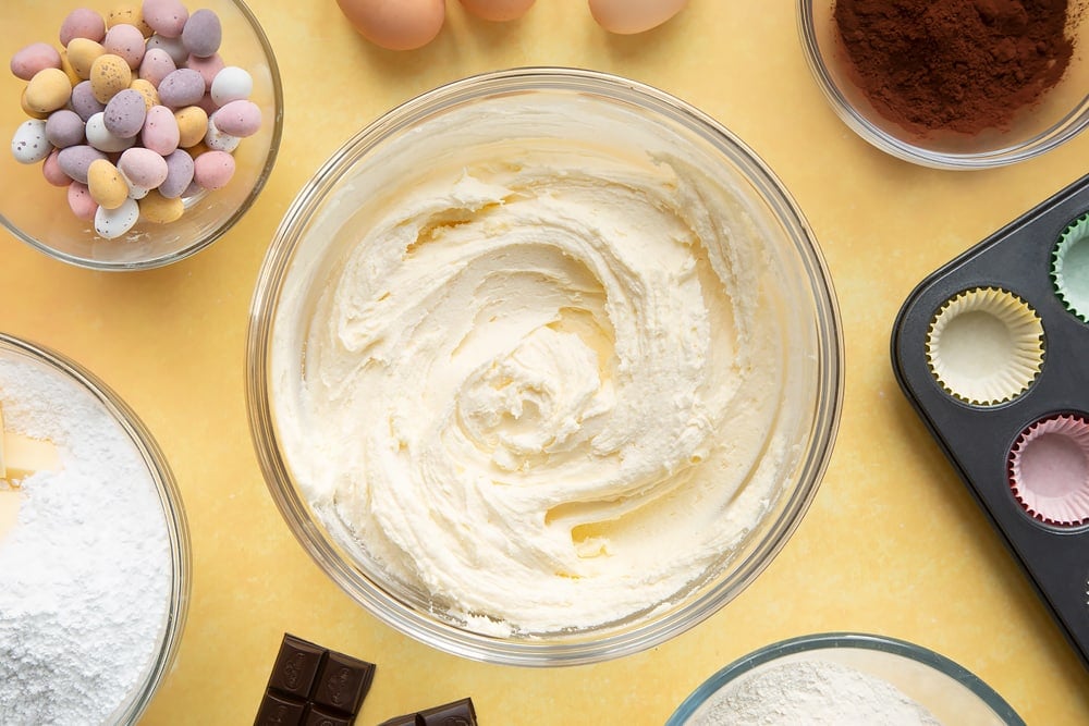 Overhead shot of frosting in a large clear bowl