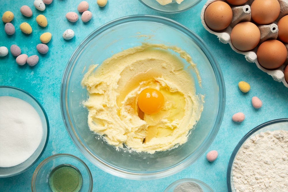 Overhead shot of mixed butter and egg in a large clear bowl