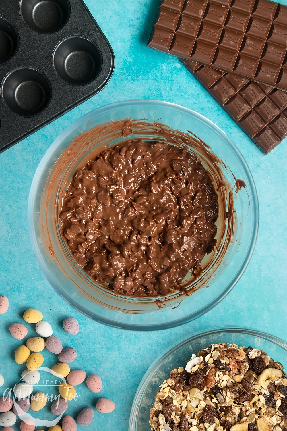 Overhead shot of chocolate muesli mix in a large clear bowl